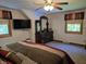 Bedroom featuring a dark wood dresser and mirror, carpeted floor, and large windows for natural light at 6605 Donnelly Dr, Brownsburg, IN 46112