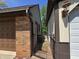 View of the side of a brick and siding house with a fenced-in area at 6605 Donnelly Dr, Brownsburg, IN 46112