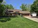 Charming brick home features a well-manicured lawn and lovely landscaping with a two-car garage and additional outbuilding at 6605 Donnelly Dr, Brownsburg, IN 46112
