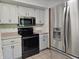 Kitchen features stainless steel appliances, white cabinetry, and black countertops providing modern amenities at 6605 Donnelly Dr, Brownsburg, IN 46112