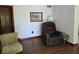 Cozy living room with a comfortable recliner, wood floors, and a view of the doorway at 6605 Donnelly Dr, Brownsburg, IN 46112