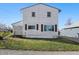 Rear view of two-story house with symmetrical windows and tidy lawn at 180 N Highland St, Morgantown, IN 46160