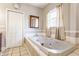 Bright bathroom with large jetted tub and neutral tiling at 2036 N Talbott St, Indianapolis, IN 46202
