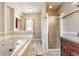 Bathroom with a jetted tub, separate shower, and wooden vanity at 2036 N Talbott St, Indianapolis, IN 46202