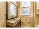 Close up on a bathroom vanity with a gray countertop and black sink with natural light at 2036 N Talbott St, Indianapolis, IN 46202