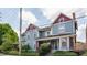 Charming blue house with red trim, well-maintained landscaping, and a cozy front porch at 2036 N Talbott St, Indianapolis, IN 46202