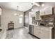 Well-lit kitchen with stainless steel appliances, granite countertops, and modern lighting fixtures at 2036 N Talbott St, Indianapolis, IN 46202