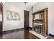 Living room featuring dark hardwood floors and a fireplace with decorative wood detailing at 2036 N Talbott St, Indianapolis, IN 46202