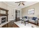 Bright living room boasts a fireplace, hardwood floors, access to other spaces, and tasteful decor at 2036 N Talbott St, Indianapolis, IN 46202