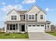 Two-story home featuring a two-car garage and a well-manicured lawn under a bright, cloudy sky at 4180 Bozeman Way, Bargersville, IN 46106