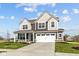 Stylish gray two-story home with a covered front porch, two-car garage, and manicured lawn and landscaping at 4180 Bozeman Way, Bargersville, IN 46106