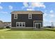 The back of a home has sod, brick foundation and a sliding glass door at 4180 Bozeman Way, Bargersville, IN 46106