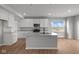 Modern kitchen features white cabinets, stainless steel appliances, a spacious island, and sleek countertops at 4180 Bozeman Way, Bargersville, IN 46106