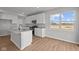 Bright, white kitchen with stainless steel appliances, center island, and a large window offering natural light at 4180 Bozeman Way, Bargersville, IN 46106