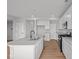 Modern kitchen with white cabinets, stainless appliances, a center island, and hard wood floors at 4180 Bozeman Way, Bargersville, IN 46106