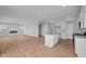 Open-concept kitchen with island, flowing into a living area with a fireplace, creating a cozy atmosphere at 4180 Bozeman Way, Bargersville, IN 46106