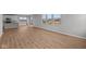 Spacious open-concept living room showcasing pristine hardwood floors and plenty of natural light from large windows at 4180 Bozeman Way, Bargersville, IN 46106
