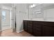 Bathroom featuring double vanity with dark wood cabinets and a large mirror at 4186 Dutton Dr, Bargersville, IN 46106