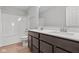Bathroom featuring dual sinks, white countertops, wood cabinets, and a shower with tub at 4186 Dutton Dr, Bargersville, IN 46106