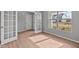 Bright bedroom featuring wood laminate flooring, a large window, and glass paneled french doors at 4186 Dutton Dr, Bargersville, IN 46106