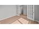 Bright bedroom featuring wood laminate flooring, a large window, and glass paneled french doors at 4186 Dutton Dr, Bargersville, IN 46106