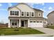 Charming two-story home with a two car garage and a covered entryway, surrounded by a well-maintained lawn and landscaping at 4186 Dutton Dr, Bargersville, IN 46106