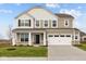 Charming two-story home with a two car garage and a covered entryway, surrounded by a well-maintained lawn and landscaping at 4186 Dutton Dr, Bargersville, IN 46106