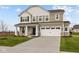 Charming two-story home with a two car garage and a covered entryway, surrounded by a well-maintained lawn and landscaping at 4186 Dutton Dr, Bargersville, IN 46106