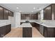 Spacious kitchen featuring stainless steel appliances, dark wood cabinetry, white countertops, an island and an open layout at 4186 Dutton Dr, Bargersville, IN 46106
