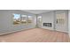 Spacious living room with luxury wood flooring, fireplace, and large windows at 4186 Dutton Dr, Bargersville, IN 46106