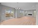 Bright, open-concept living room featuring wood flooring, fireplace, and sliding glass doors at 4186 Dutton Dr, Bargersville, IN 46106