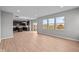 Open-concept living space with wood flooring and kitchen in the background at 4186 Dutton Dr, Bargersville, IN 46106