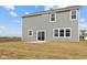 Backyard features a sliding glass door leading onto a small patio and a spacious, newly seeded lawn at 4193 Bozeman Way, Bargersville, IN 46106