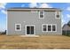 Backyard features a sliding glass door leading onto a small patio and a spacious, newly seeded lawn at 4193 Bozeman Way, Bargersville, IN 46106