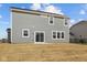 Backyard features a sliding glass door leading onto a small patio and a spacious, newly seeded lawn at 4193 Bozeman Way, Bargersville, IN 46106