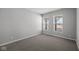A bright bedroom with carpet, neutral walls, and a pair of windows overlooking an exterior view at 4193 Bozeman Way, Bargersville, IN 46106