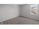 This inviting bedroom has neutral carpeting and a large window providing natural light with a glimpse of the outdoors at 4193 Bozeman Way, Bargersville, IN 46106