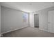 Bright bedroom featuring neutral carpeting, a window, closet and a door at 4193 Bozeman Way, Bargersville, IN 46106