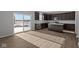 Modern kitchen with dark cabinetry, stainless steel appliances, and an island, adjacent to the dining area at 4193 Bozeman Way, Bargersville, IN 46106
