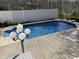A sparkling in-ground pool is surrounded by a concrete patio and a privacy fence at 6902 Creekridge Trl, Indianapolis, IN 46256