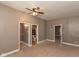 View of the neutral-toned bedroom with ceiling fan and a bathroom adjacent at 741 Greer St, Indianapolis, IN 46203