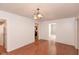 Bright dining room featuring wood floors, white walls, an open entryway, and modern light fixture at 741 Greer St, Indianapolis, IN 46203