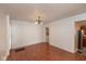 Open dining room featuring wood floors, white walls, a modern light fixture, and open entryway at 741 Greer St, Indianapolis, IN 46203