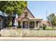 Charming two-story home featuring a large front porch and a white picket fence at 741 Greer St, Indianapolis, IN 46203