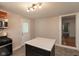 Functional kitchen featuring an island with breakfast bar, stainless steel appliances, and a door to the outside at 741 Greer St, Indianapolis, IN 46203