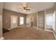 Bright living room featuring neutral walls, a ceiling fan, carpet flooring, and a doorway to another room at 741 Greer St, Indianapolis, IN 46203