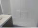 Bright bathroom with a white tub, gray vanity and clean design at 2021 N Graham Ave, Indianapolis, IN 46218