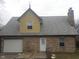 A garage with a white door is attached to a brick home at 2021 N Graham Ave, Indianapolis, IN 46218