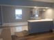 An open kitchen with a breakfast bar and neutral colored cabinetry under recessed lighting at 2021 N Graham Ave, Indianapolis, IN 46218