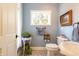 Charming powder room featuring elegant sink, patterned floors, and stylish decor at 7258 N Richardson Dr, Morgantown, IN 46160